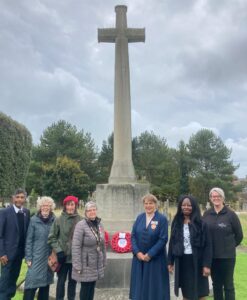 The Mayor of Seaford stand with other dignitaries standing in from of a war grave at Seaford cemetery.