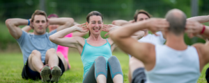 Group of people attending an outside fitness class.